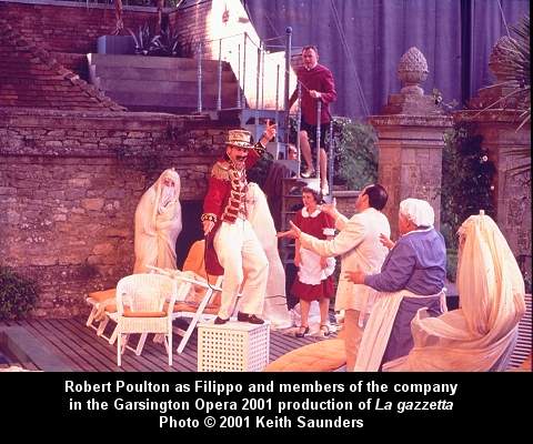 Robert Poulton as Filippo and members of the company in the Garsington Opera 2001 production of 'La gazzetta'. Photo (c) 2001 Keith Saunders