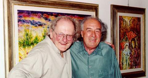 Sergio Pizzerri (right) with Bill Newman and Pizzerri's paintings.