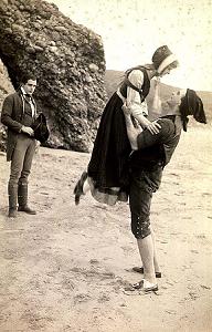 Enoch lifts Annie as Philip looks on. A still from the 1915 film 'Enoch Arden' by D W Griffith and Christie Cabanne