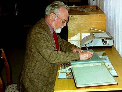 John McCabe signing the official guestbook at Klaipeda Conservatory. Photo © 2003 Tamami Honma