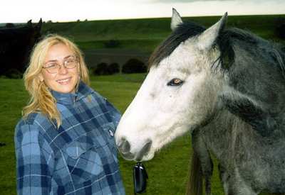 Sonja with a horse in New Zealand. Photo © 2003 Hans Zulauf