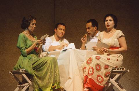 The passengers (from left) Paula (Suzanna Guzmán), Arcadio (Chad Shelton), Alvaro (Hector Vasquez) and Rosalba (Ana Maria Martinez) play a game of cards. Photo: George Hixson/Houston Grand Opera