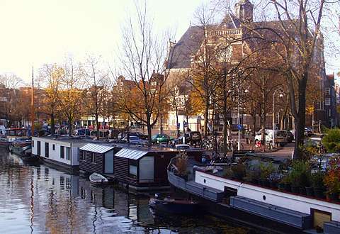 The Prinsengracht, one of Amsterdam's three main canals, with the Noorderkerk, home to many classical concerts, behind. The large Monday market uses the area between the canal and the church. Photo: Keith Bramich 2003