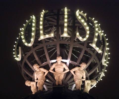 Terracotta statues and the rotating ball at the top of the London Coliseum. Photo © Grant Smith