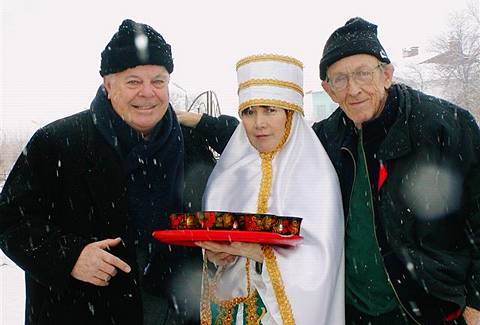 Mark Malkovich (left) and Howard Smith receive a traditional Kazakh welcome with confectionary offerings in the snow. Photo © 2004 Howard Smith