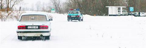 Follow the leader: Kazakh police lead the motorcade. Photo © 2004 Howard Smith