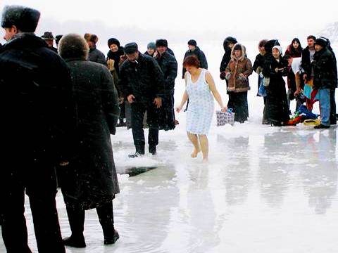 On the frozen River Ural - a Kazakh lady prepares to plunge into icy waters. Photo © 2004 Howard Smith