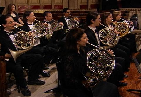A still frame of eight horn players. Photo © Video Arts International