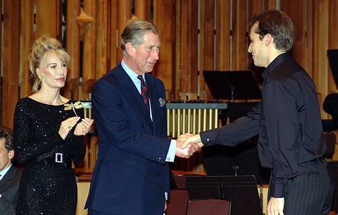Fabien Gabel receives his prize from the competition's patron, the Prince of Wales, with Donatella Flick, left. Photo © Chris Christodoulou