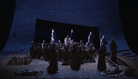 Waltraud Meier (Kundry) leads the procession along the track, at the end of Act 3. DVD screenshot © 2005 Opus Arte