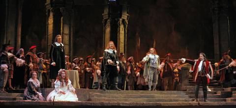 The cast of San Diego Opera's 'Lucia di Lammermoor' surrounded by San Diego Opera Chorus. Kneeling (left to right): soprano Kathleen Halm (Alisa) and soprano Angela Gilbert (Lucia). Standing (left to right): bass Reinhard Hagen (Raimondo), tenor Richard Leech (Edgardo), tenor Bryan Register (Arturo) and baritone Dalibor Jenis (Lord Enrico Ashton). Photo © 2006 Ken Howard