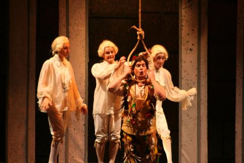 The Three Spirits help Papageno (Shon Sims) to put a noose around his neck. Photo © Robin Grant