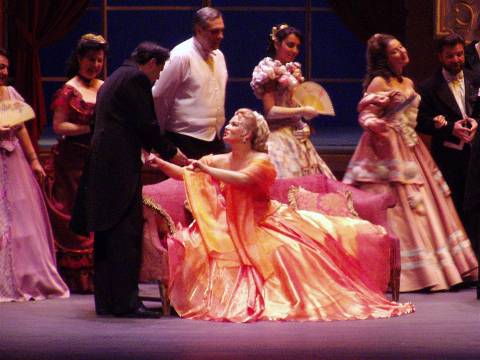 Marina Viskvorkina as Violetta, with members of the chorus, in Teatro Lirico d'Europa's 'La Traviata'