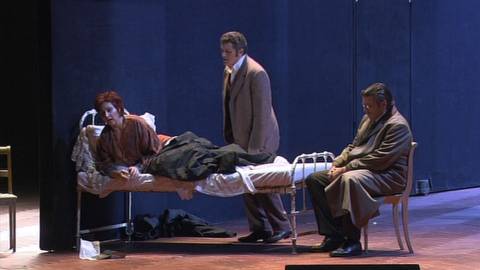 Thomas Hampson (Giorgio Germont, right) and Piotr Beczala (Alfredo Germont) at the bedside of Eva Mei (Violetta Valéry) in Act 3 of 'La Traviata'. DVD screenshot © 2005 Zurich Opera House