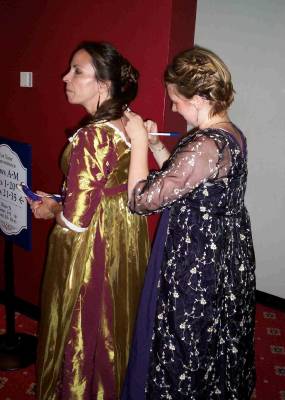 Lindsay Baker uses Amanda Jacobs' back to sign an autograph. Photo © 2006 Kelly Ferjutz