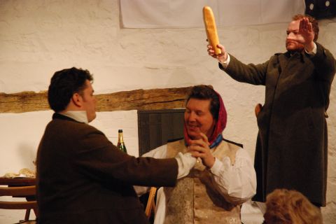 Colline (Martin Lamb, conducting with bread baton) and Marcello (David Palmer, in headscarf) whip up the fun. Photo © 2007 Sebastian Fattorini, Skipton Castle
