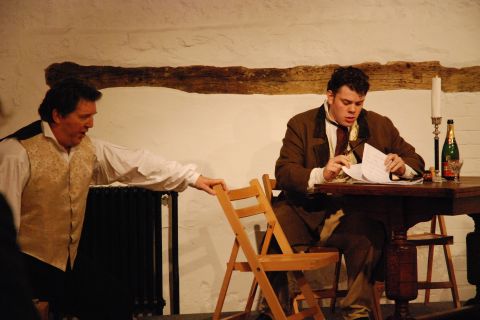 The thoughtful Marcello (David Palmer, left) and a reflective Rodolfo (Richard Williams, right, at workdesk) in Heritage Opera's 'La Bohème'. Photo © 2007 Sebastian Fattorini, Skipton Castle