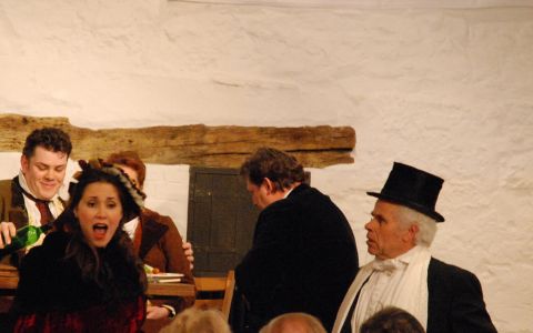 Musetta tries in vain to be rid of her tiresome and solicitous suitor Alcindoro (Adrian Lawson, right). Photo © 2007 Sebastian Fattorini, Skipton Castle