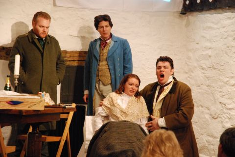 Colline (still in his coat) and Schaunard look on as Rodolfo supports the dying Mimi in Act 4 of Puccini's opera. Photo © 2007 Sebastian Fattorini, Skipton Castle