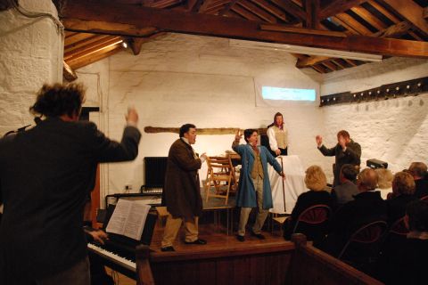 High jinks in the garret, led by the versatile Schaunard (Andrew Mayor). Photo © 2007 Sebastian Fattorini, Skipton Castle