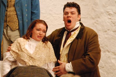 Sadly time is now running out - Mimi (Serenna Wagner) and Rodolfo (Richard Williams) in Act 4. Photo © 2007 Sebastian Fattorini, Skipton Castle