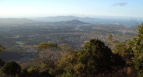 Townsville from Mount Stuart, looking north. Castle Hill, almost on the shore of Cleveland Bay, is in line with Magnetic Island. Ross River winds across the middle of the picture. Photo © 2004 Malcolm Tattersall