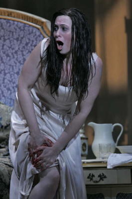 Alexandra Deshorties as Violetta, after having just injected herself with an opiate, in Arizona Opera's 'La Traviata'. Photo © 2008 Scott Humbert