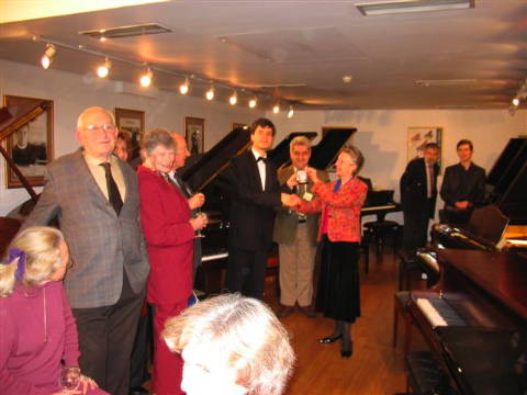 Presentation of the Beethoven Medal to first prize winner Andrejs Osokins by Petronella Dittmer, the new Lady Master of the Worshipful Company of Musicians. From left to right: Heleen Mendl-Schrama (correspondent for the Dutch Pianowereld), Barry Saipe and Norma Fisher, Audrey Ellison (J Audrey Ellison International Artists' Management), William Brown CBE (Patron), Nadia Lasserson (foreground), first prize winner Andrejs Osokins, Marios Papadopoulos (chairman of the jury) and Petronella Ditmer. Photo © 2008 Harry Atterbury