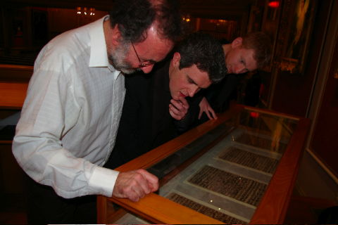 Iain Ledingham (left) and colleagues examine the manuscript of BWV 128 