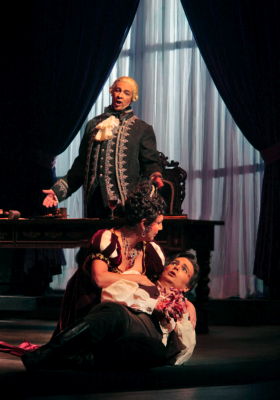 Sylvie Valayre as Floria Tosca and Marcus Haddock as Mario Cavaradossi, with Greer Grimsley as Scarpia looking on, in San Diego Opera's production of 'Tosca'. Photo © 2009 Ken Howard