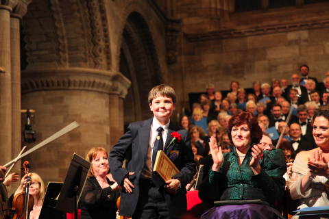 Hereford Cathedral chorister Rory Turnbull greets the rapturous applause, with front desks of the Philharmonia Orchestra (left), mezzo Catherine Wyn-Rogers (centre) and (far right) soprano Sarah Fox