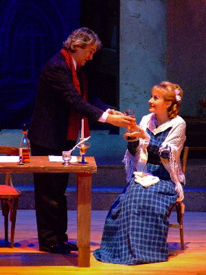 Rodolfo (Orlin Goranov) offers Mimi (Elena Razgylaeva) a glass of wine in Act I of 'La bohème'. Photo © 2009 Robin Grant