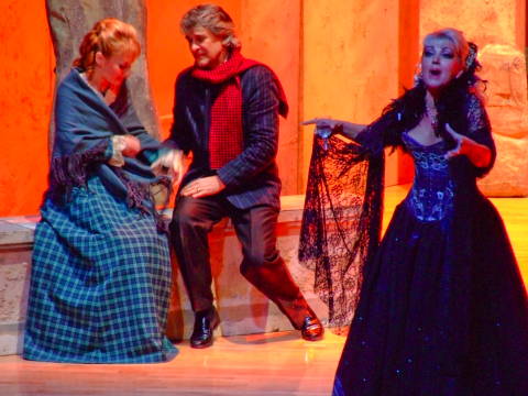 Rodolfo (Orlin Goranov) takes the hand of Mimi (Elena Razgylaeva) as Musetta (Snejana Dramcheva) calls after Marcello. Photo © 2009 Robin Grant