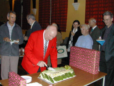 Roy cutting his birthday cake with members of Mornington Sinfonia. Photo © 2003 Lynn Norris